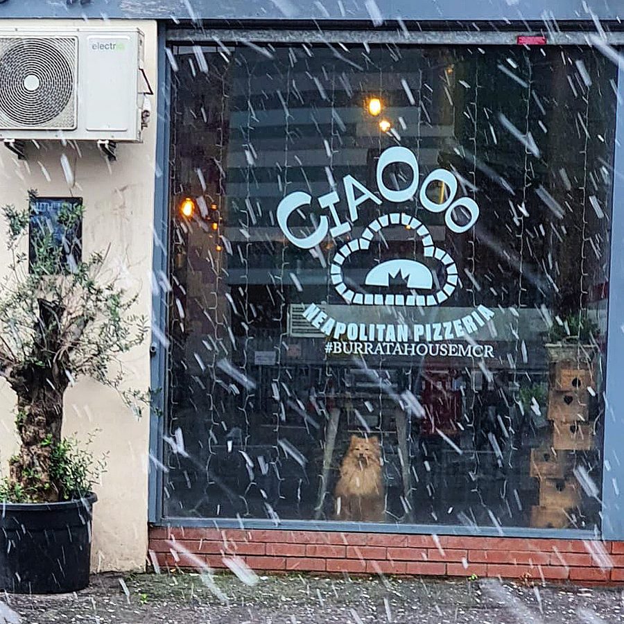 The Ciaooo shopfront on Swan Street, its Neapolitan Pizzeria window vinyl seen through falling snow.